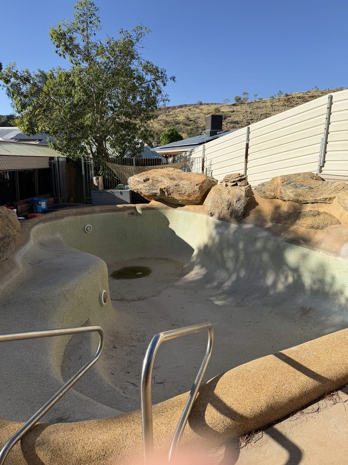 Stained, drained pool before acid wash