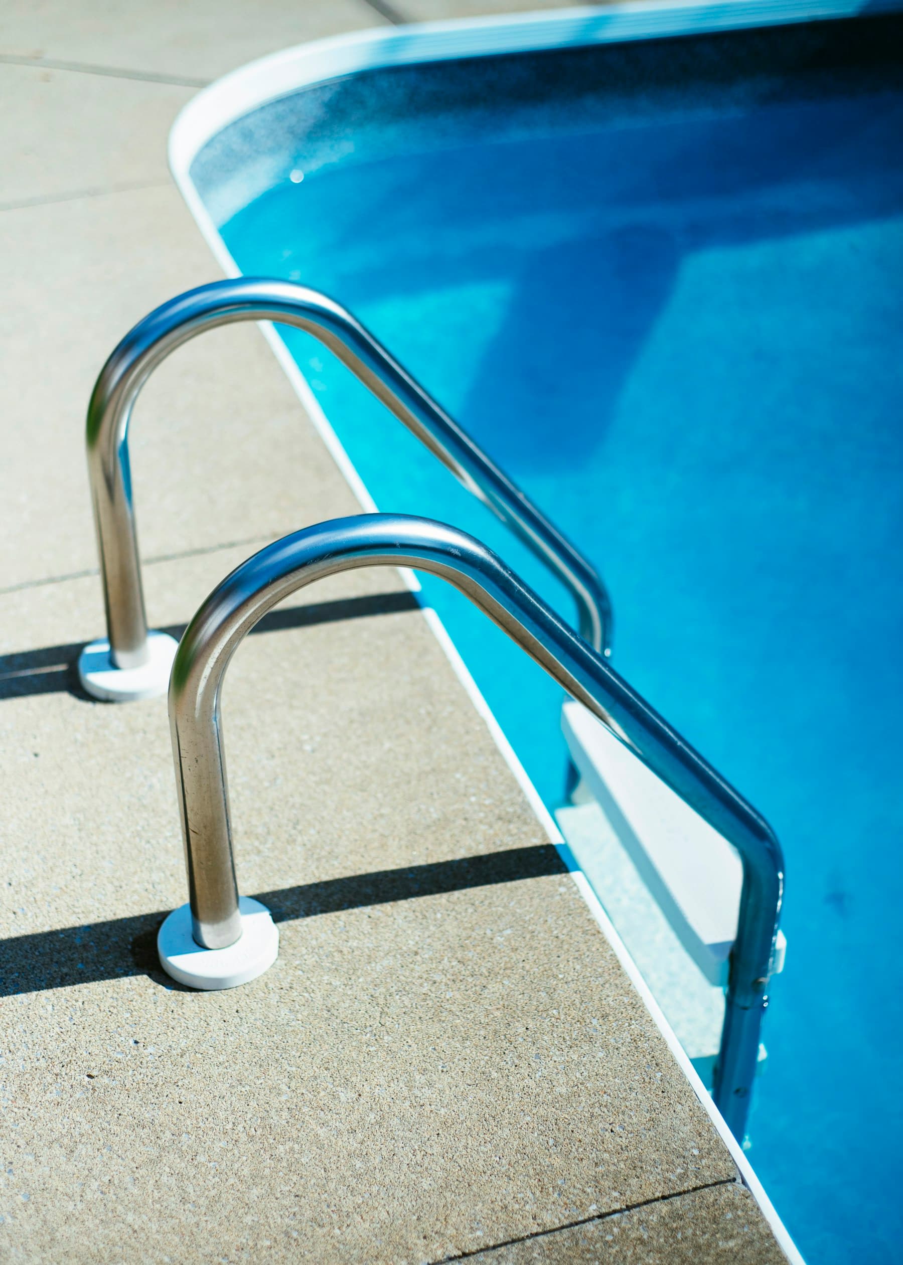 Pool ladder and clear blue water