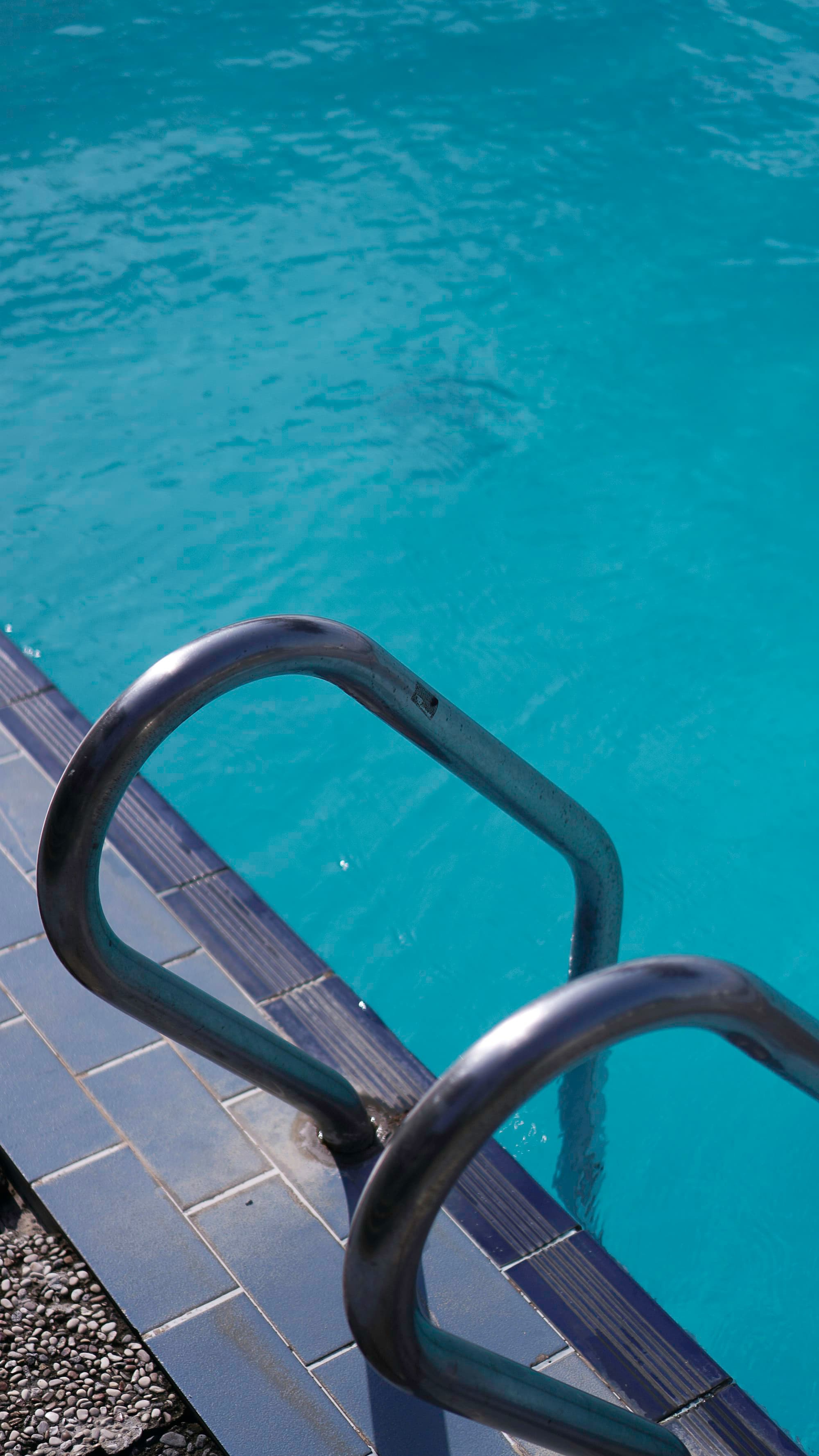 Pool handrail detail beside clear water